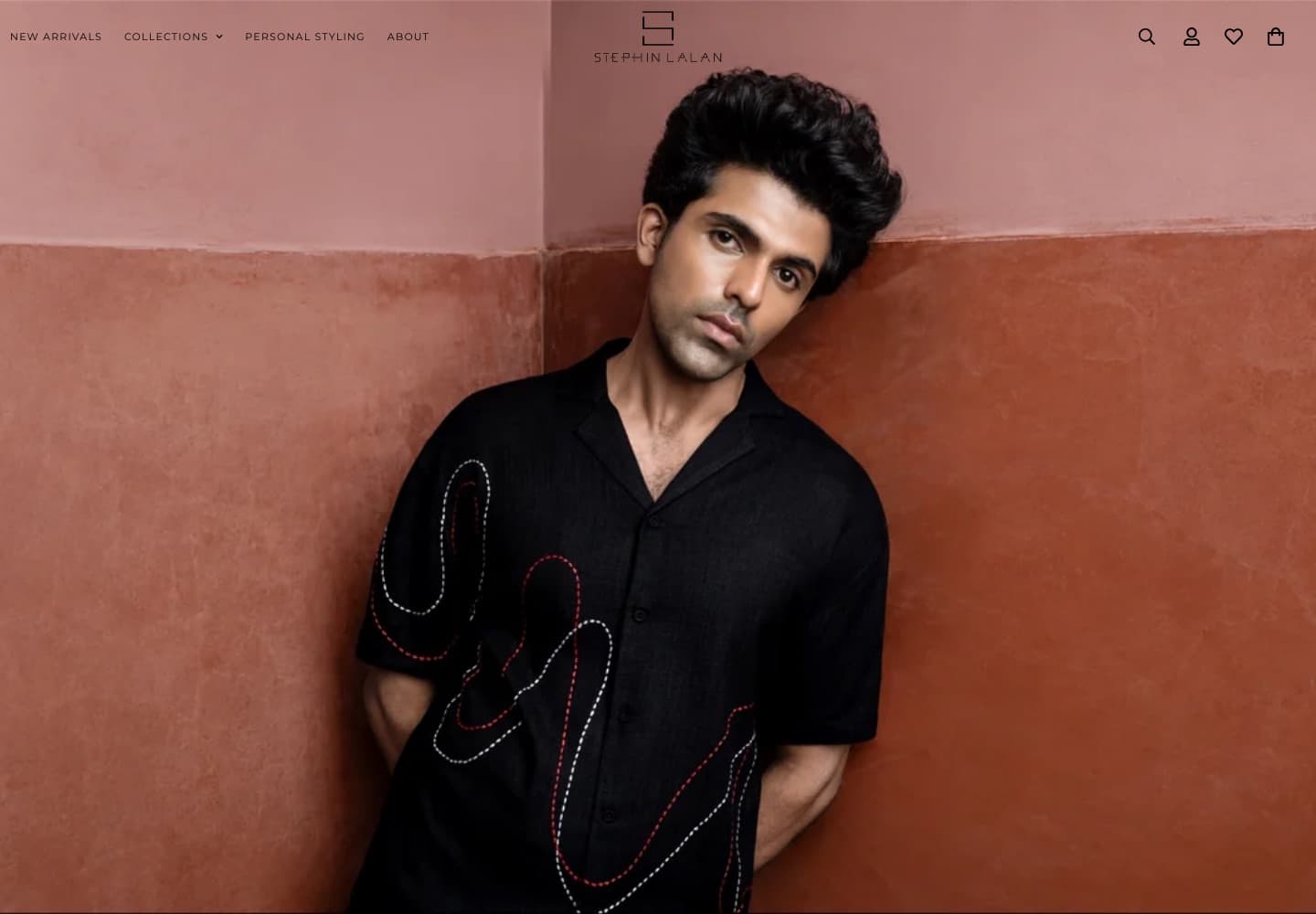 Stephin Lalan homepage showing a model in an embroidered black shirt